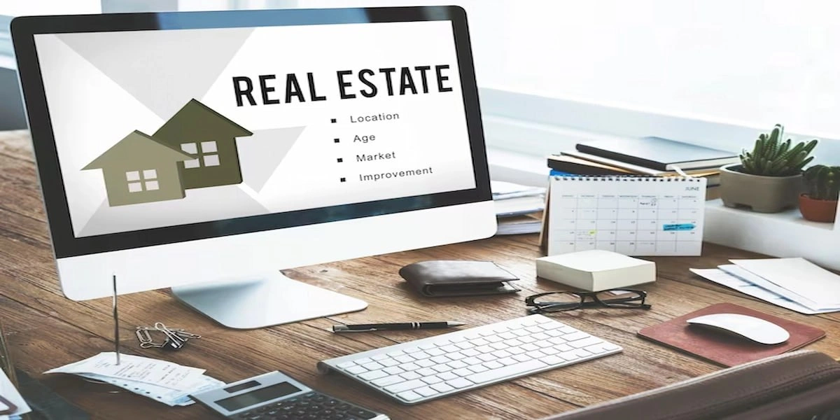 ordinateur_avec_le_mot_real_estate_en_fond_d_ecran Ordinateur avec le mot real estate en fond d'ecran